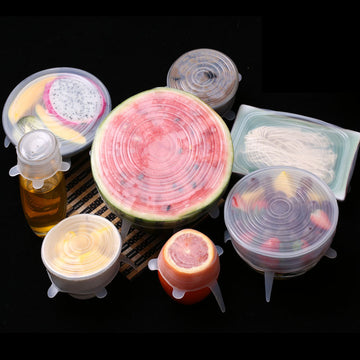 Silicone food covers on various fruits and containers against a black background; Silicone stretch lids reusable food cover set