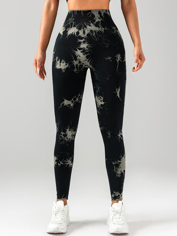 Person wearing black tie-dye leggings on a white background