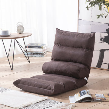Brown floor pillow on a wooden floor with a table and books in the background; Foldable single lazy sofa recliner chair