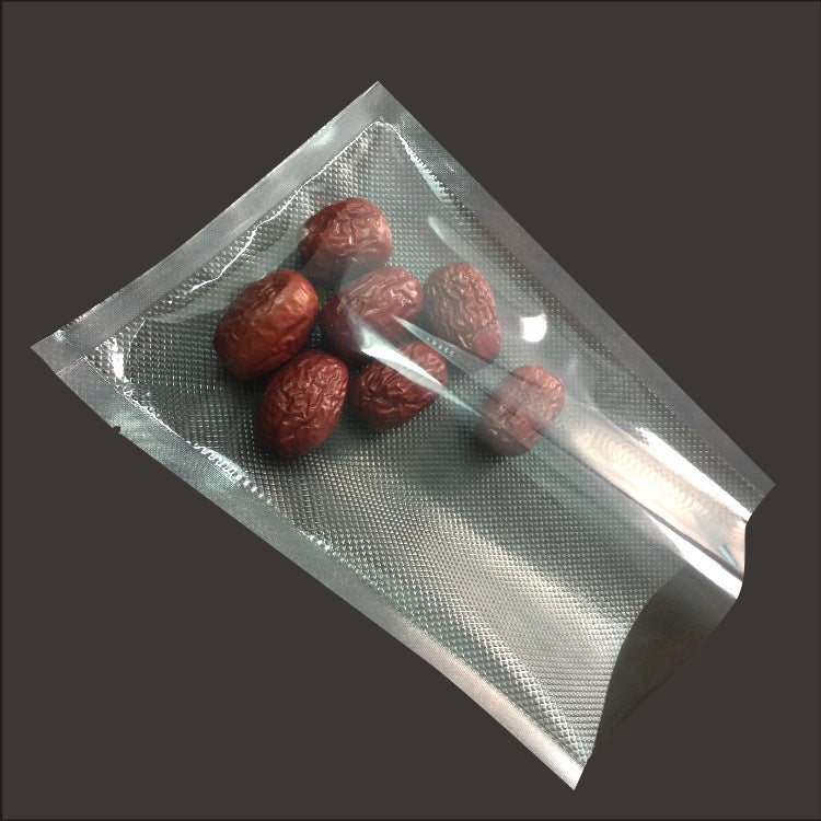 Clear plastic bag with red dates on a dark background; Vacuum sealer food storage rolls in multiple widths