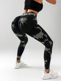 Person wearing black and gray tie-dye leggings on a white background