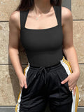 Woman wearing tie-dye workout jumpsuit in front pose, showing high waist & neckline cut