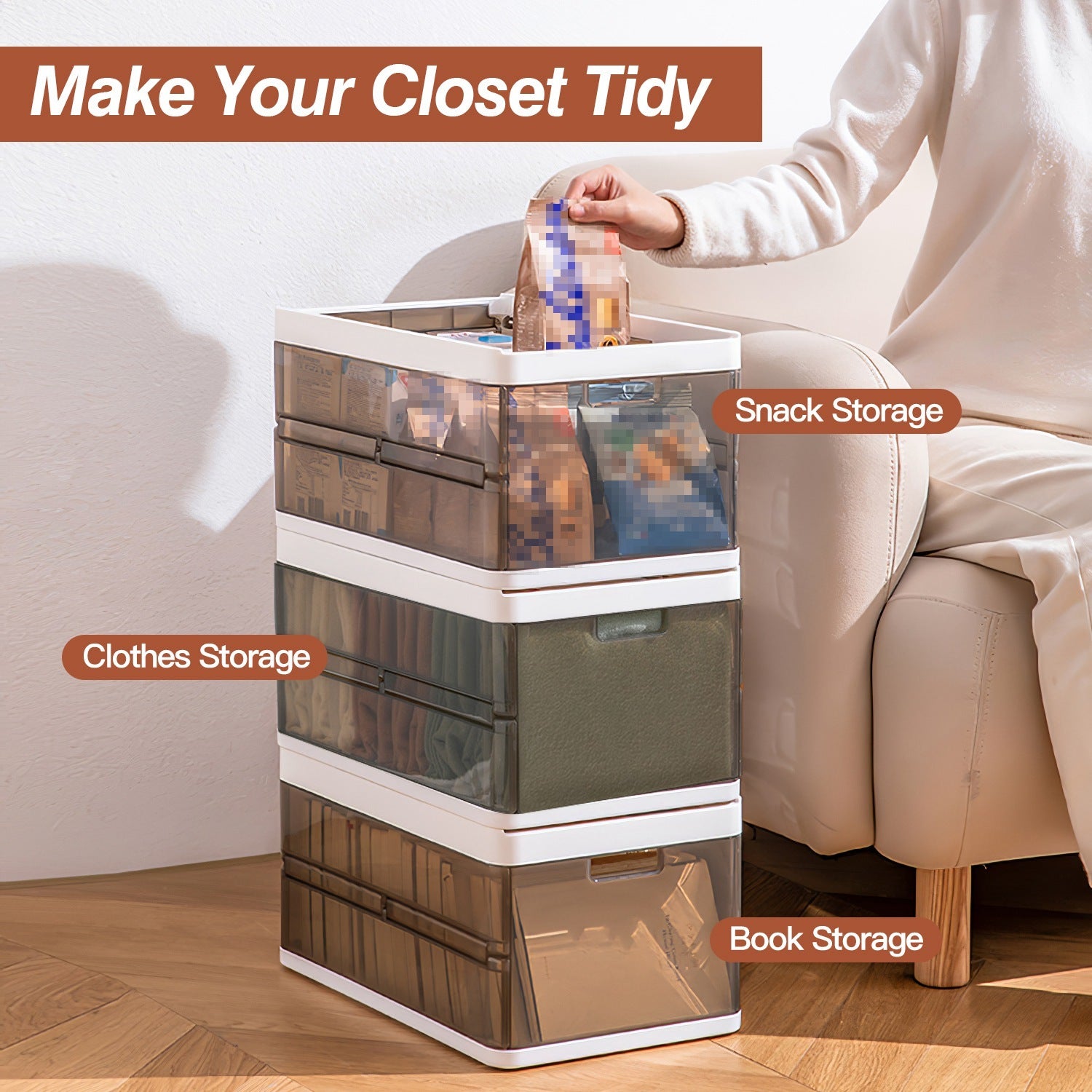 Stack of storage drawers labeled for clothes, snack, and book storage with a person sitting on a couch