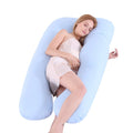 Woman lying on a U-shaped body pillow with a white background