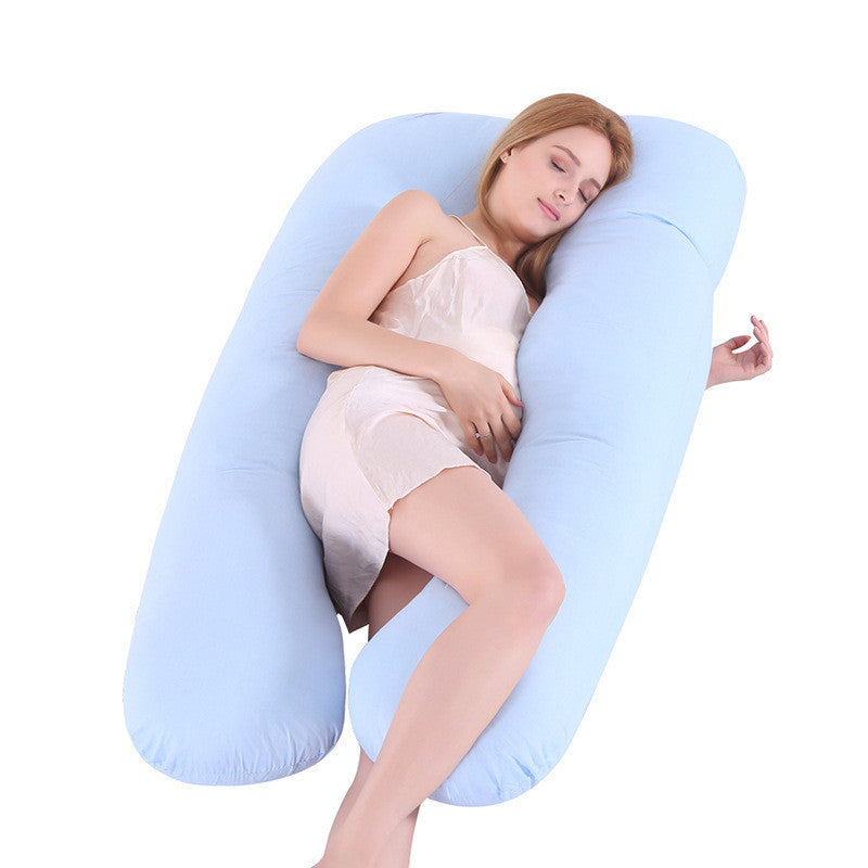 Woman lying on a U-shaped body pillow with a white background