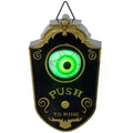 Decorative doorbell with glowing green eye and 'Push to Ring' text on a white background