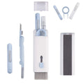 Set of skincare tools including a knife, brush, and other instruments on a white background
