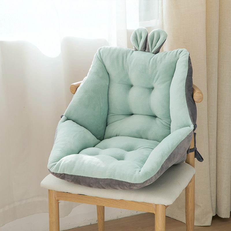 Light green and gray cushion on a wooden chair with a neutral background; Plush backrest-integrated chair cushion in neutral color