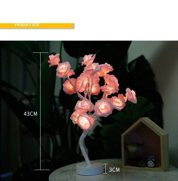 Decorative LED rose lamp with pink flowers on a dark background
