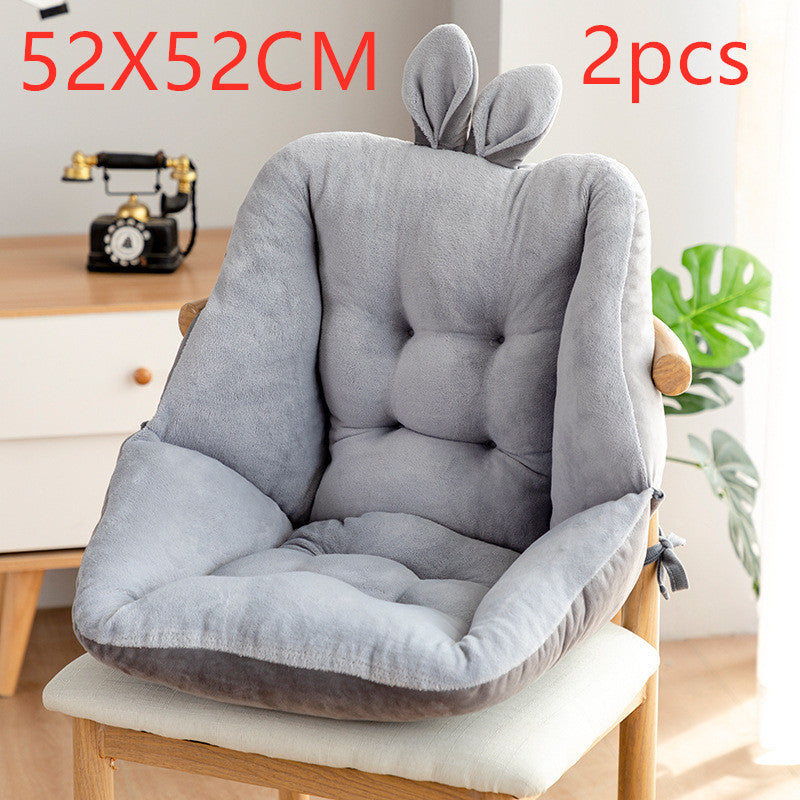 Gray chair cushion with rabbit ears on a wooden chair, placed indoors; placed on a wooden chair