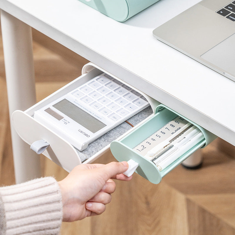 Under-desk mounted pasteable drawer holding pens and office supplies