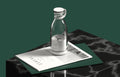 Clear Portable rechargeable USB blender with white base on a dark marble surface with a magazine underneath