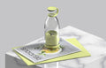 Clear Portable rechargeable USB blender with green label on a white surface with a magazine underneath