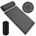 Acupressure mat with roller and flower-shaped tool on a white background