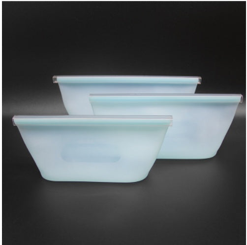 Set of three light blue glass bowls on a black background