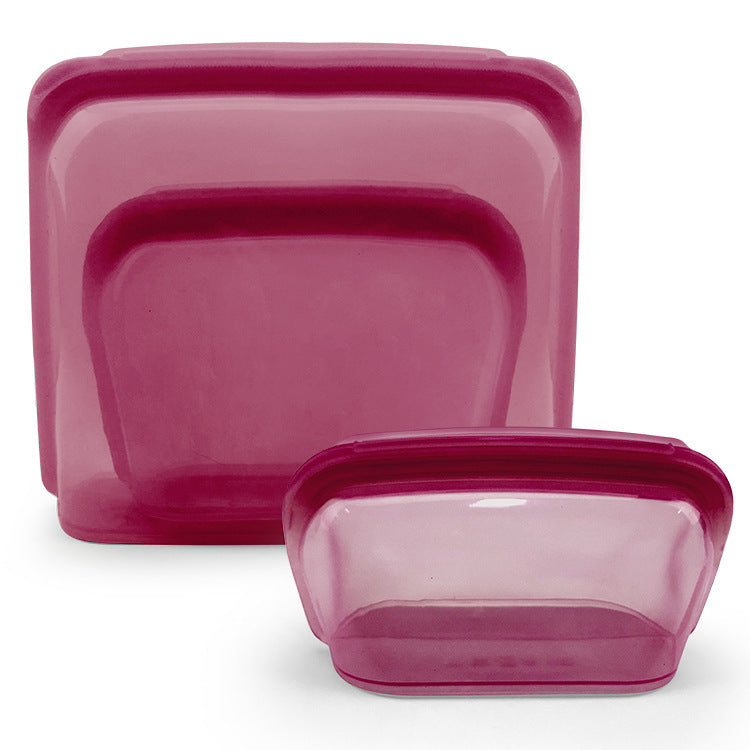 Set of three pink plastic containers with lids on a white background