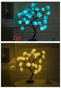 Two LED tree lights, one blue and one yellow, on a dark background.