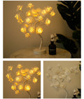 Decorative LED flower rose lamp on a marble surface with a bottle of perfume.