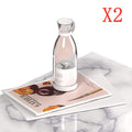 Clear Portable rechargeable USB blender with a label on a magazine on a marble surface, with 'X2' in red text above.