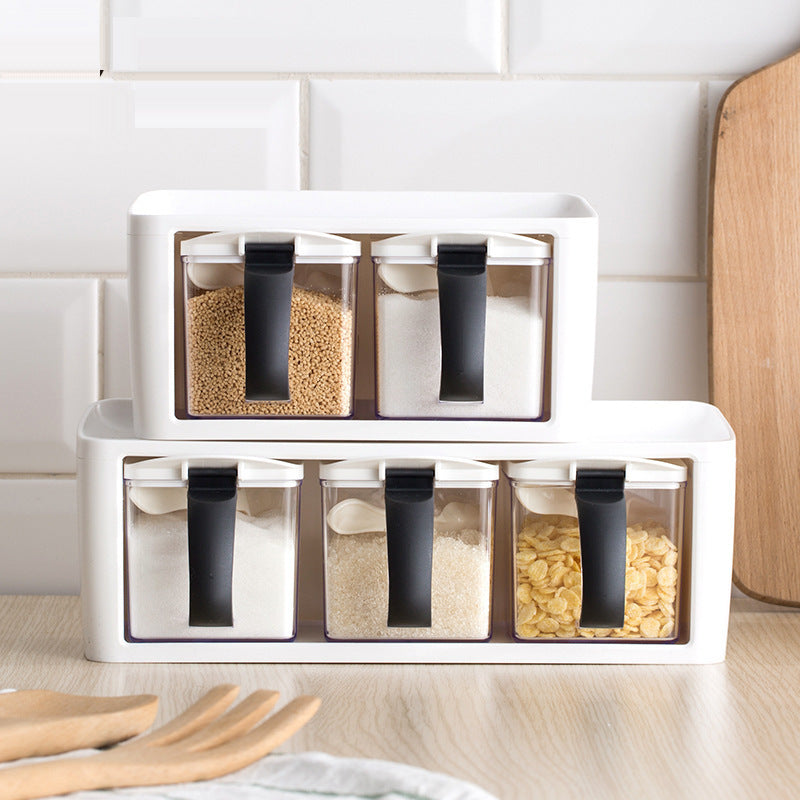 Stackable plastic spice rack with individual seasoning boxes on a kitchen counter