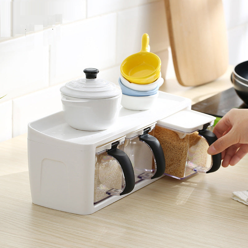Stackable plastic spice rack with individual seasoning boxes on a kitchen counter