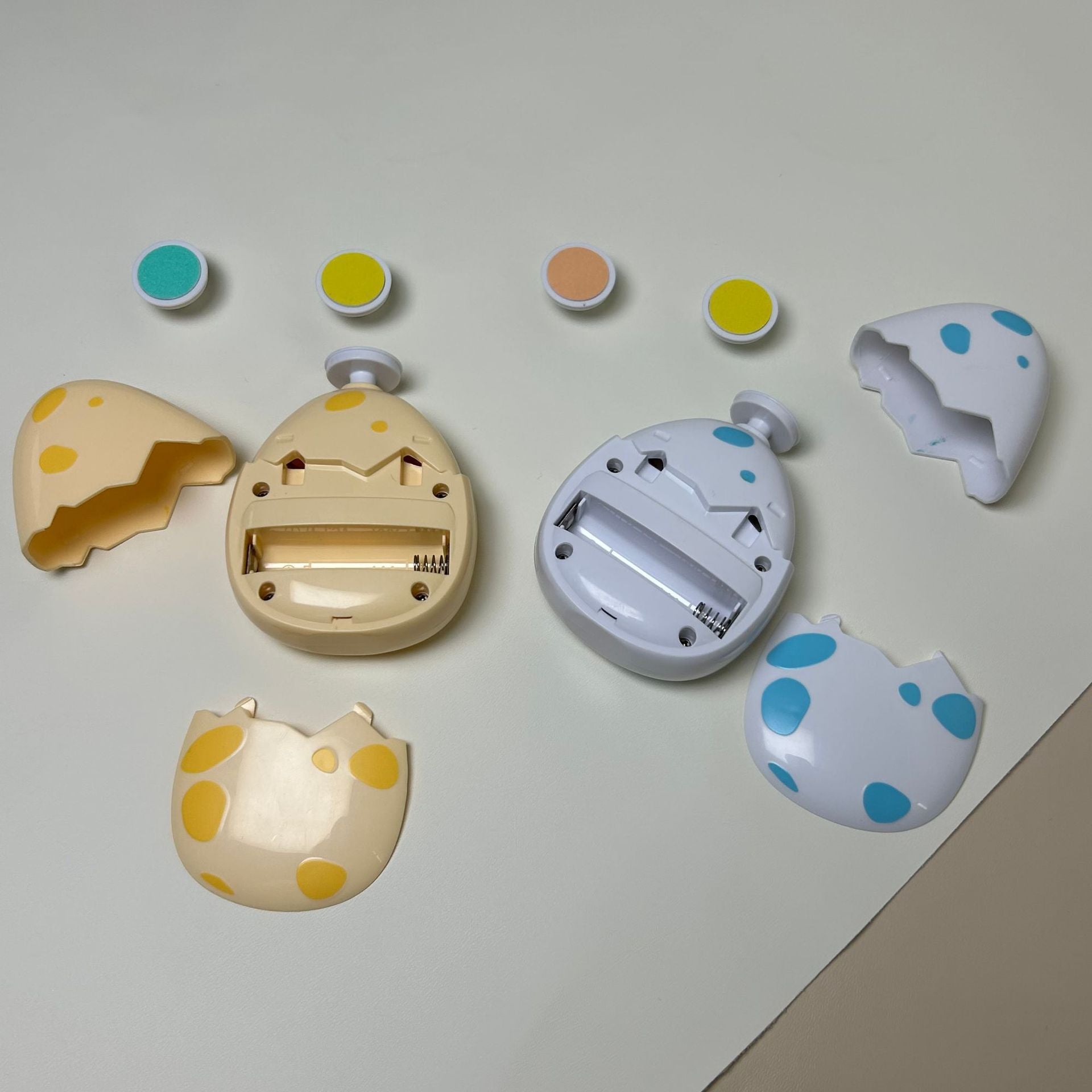 Set of colorful Children electric nail grinder with soft grinding head for safe baby nail trimming on a light gray background