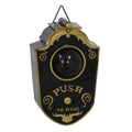 Decorative doorbell with black and gold design on a white background