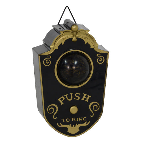 Decorative doorbell with black and gold design on a white background