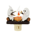Cute ghost figurines around a glowing bonfire LED lamp
