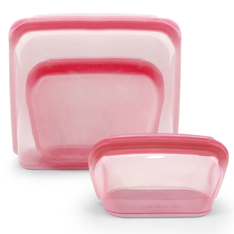 Set of pink silicone food storage containers on a white background