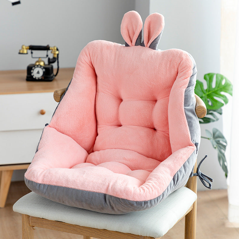 Pink and gray cushion with bunny ears on a chair in a room setting; featuring ergonomic design with tufted cotton filling