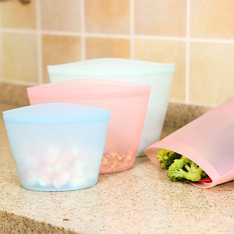 Set of 3 reusable silicone food storage bags in assorted sizes; Leakproof airtight silicone bags for kitchen storage; Transparent silicone food bags filled with fruits and vegetables; Microwave and freezer safe silicone fresh-keeping bags; Eco-friendly reusable silicone snack and meal prep bags
