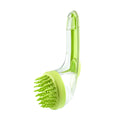 Green pet grooming brush with clear handle on a white background