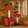 Cat playing with spider toy on Gothic red and black cat tree