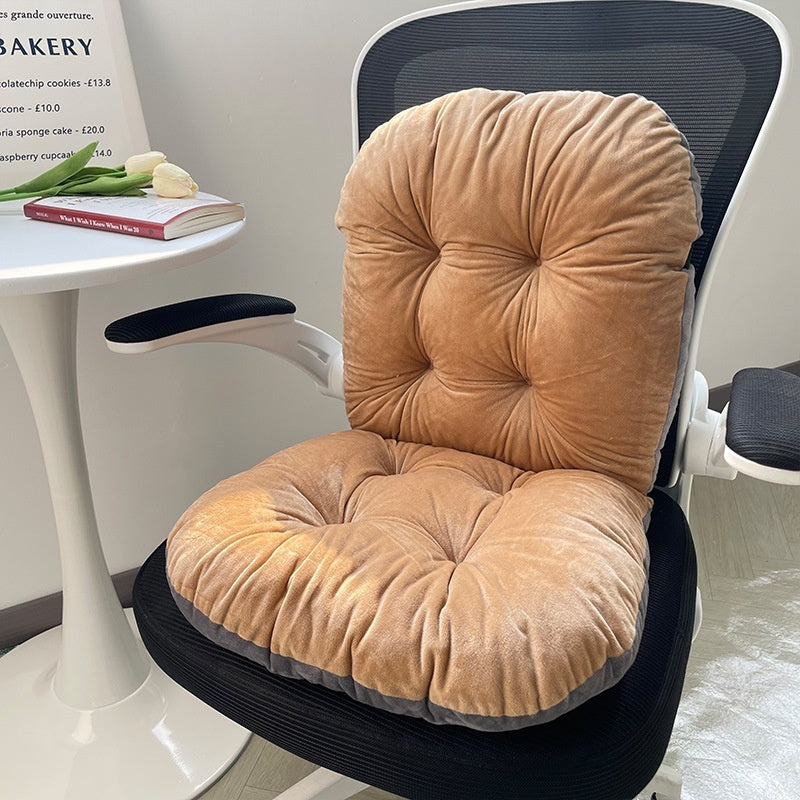 Beige cushion on a chair with a white table and bakery sign in the background; designed for comfort and support during long sitting hours