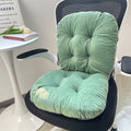 Green chair cushions on a black office chair with a table and tulips in the background; Ergonomic integrated office seat cushion with backrest in light gray viscose fabric
