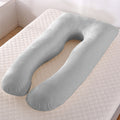Gray U-shaped body pillow on a mattress