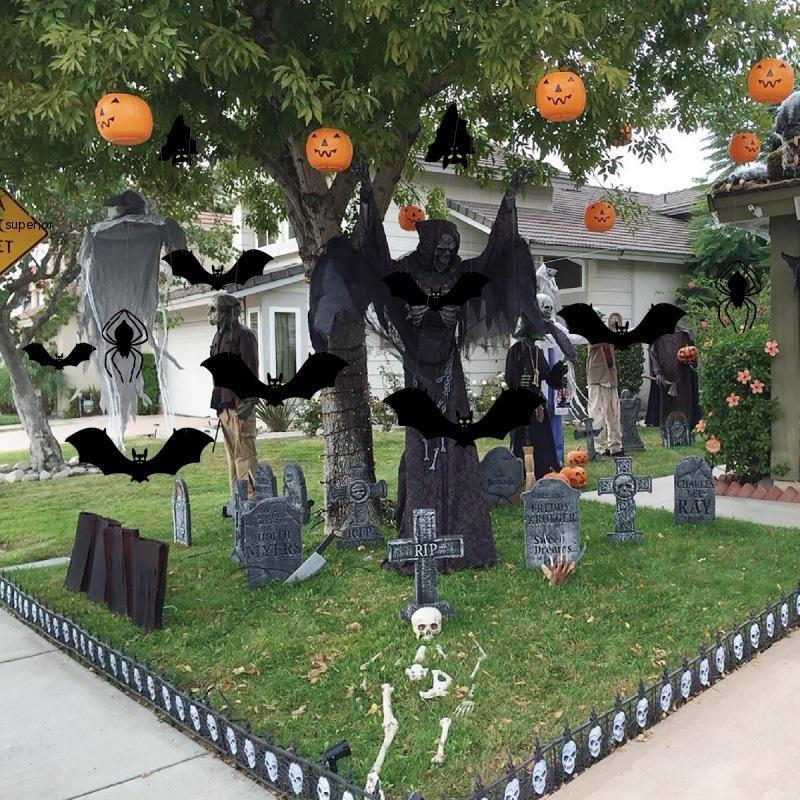 Halloween decorations of bat ornaments swaying outdoors on porch