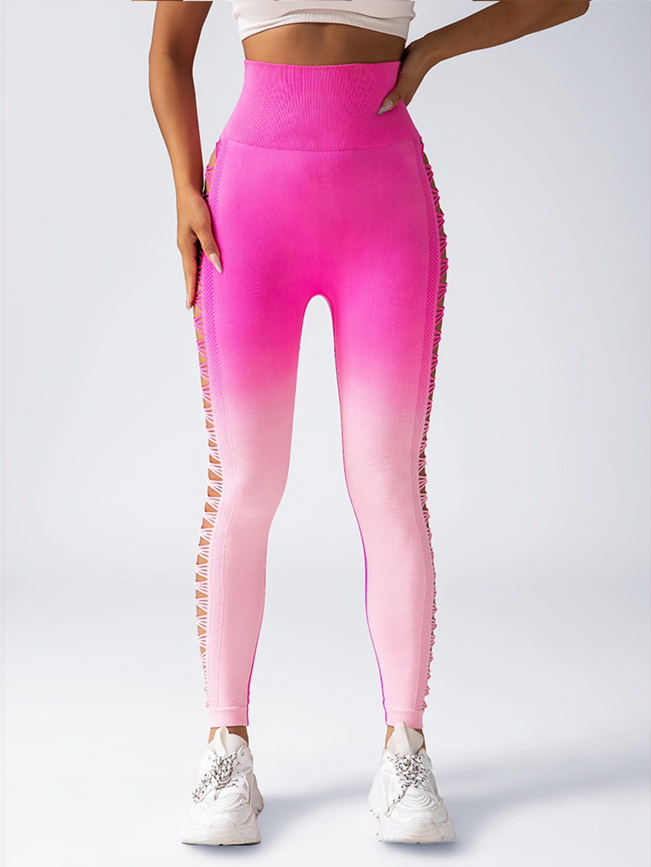 Person wearing pink gradient leggings with a subtle pattern on a white background