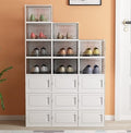 Stack of 18 shoe storage boxes neatly organized in a hallway