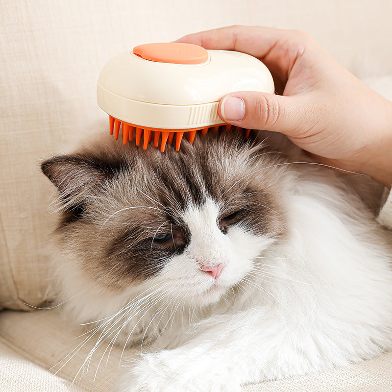 Pet grooming brush with green handle and orange bristles, used on a white cat