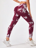Maroon and white tie-dye leggings worn by a person on a white background