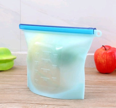 Gradient-colored measuring cup on a wooden surface with an apple and green container in the background