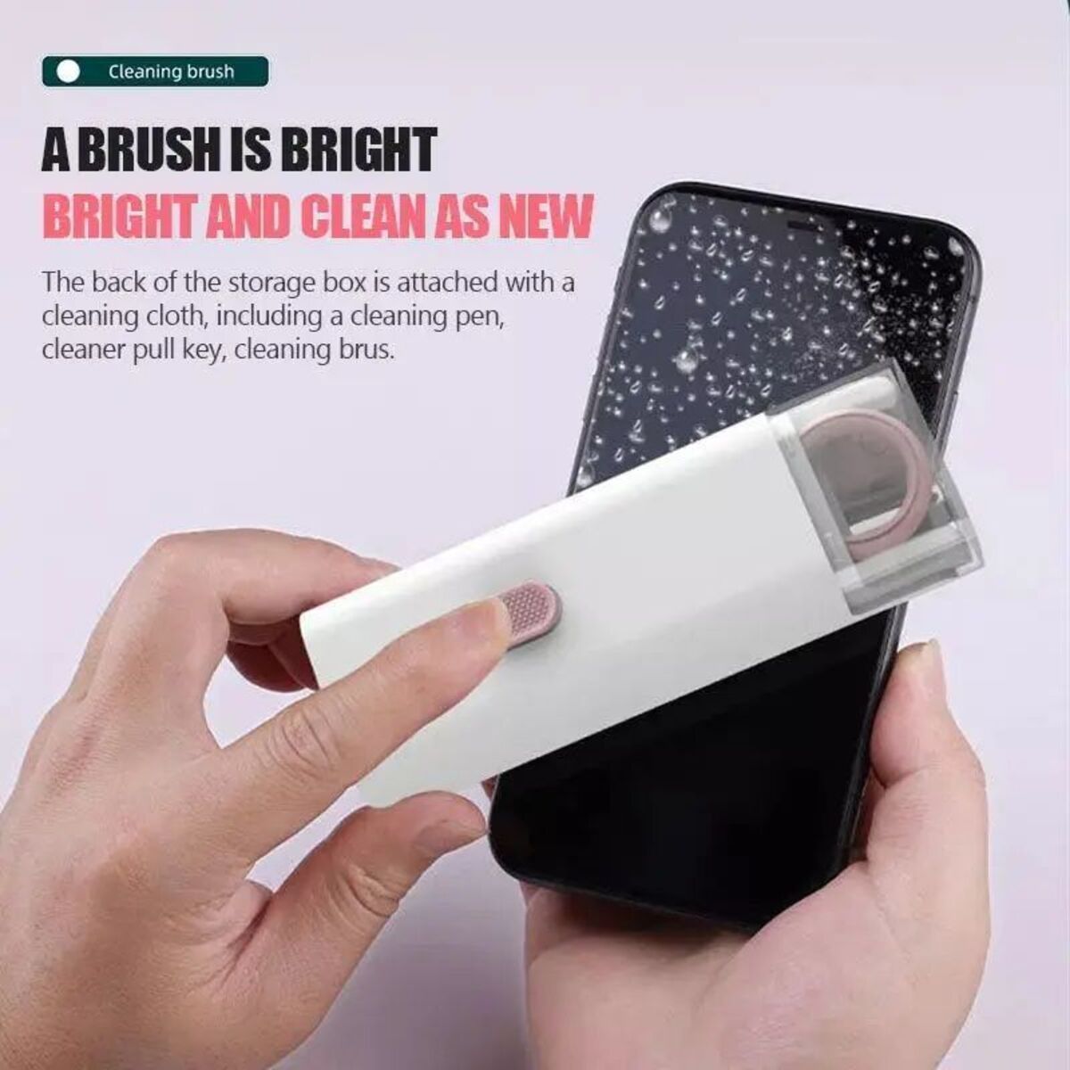 Hand holding a smartphone with cleaning brush and storage box on a light pink background