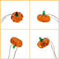 Four pumpkin-shaped string lights on a white background