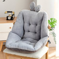 Gray cushion with bunny ears on a chair in a room setting; placed on a wooden chair