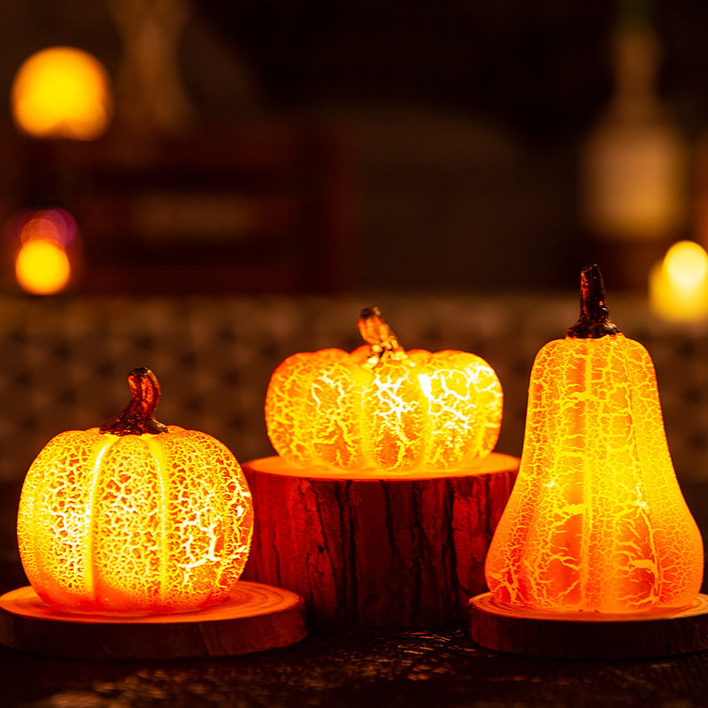 Three glowing Halloween pumpkin-shaped lights on a dark background