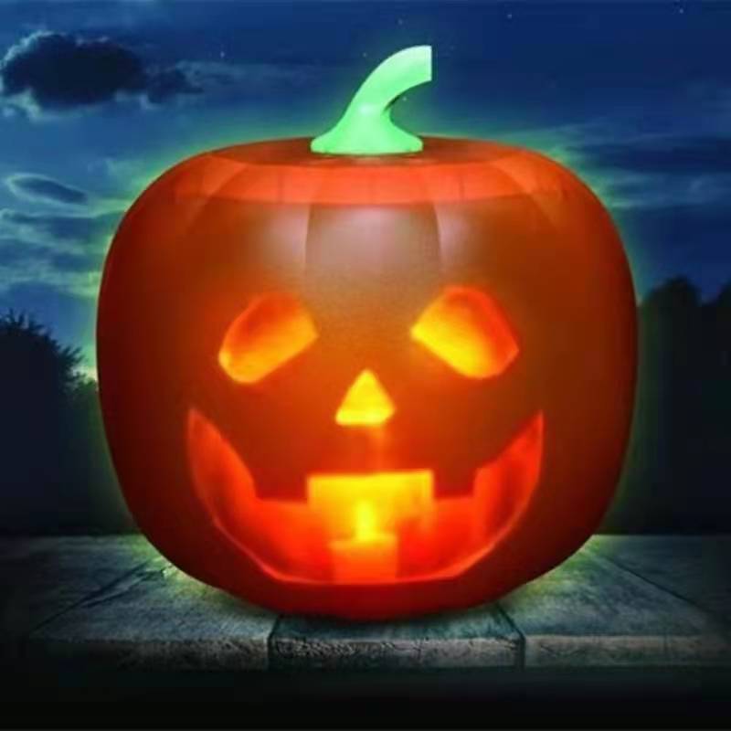 Inflatable pumpkin with a carved face on a dark background