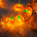 Halloween stereo pumpkin string lights on a shelf indoors