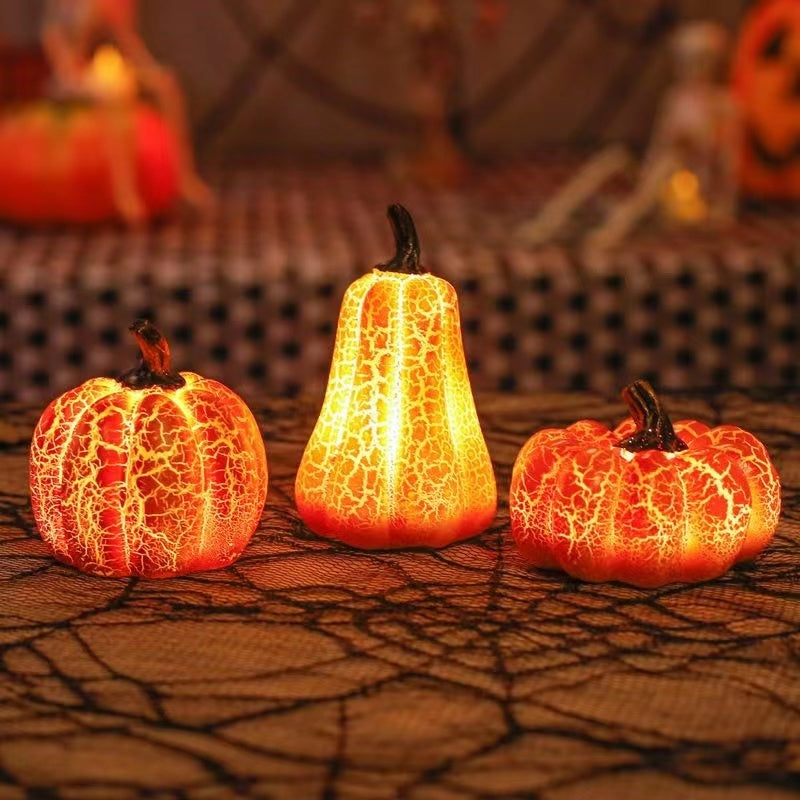 Three illuminated decorative Halloween pumpkin decor lights on a textured surface with blurred Halloween-themed background.